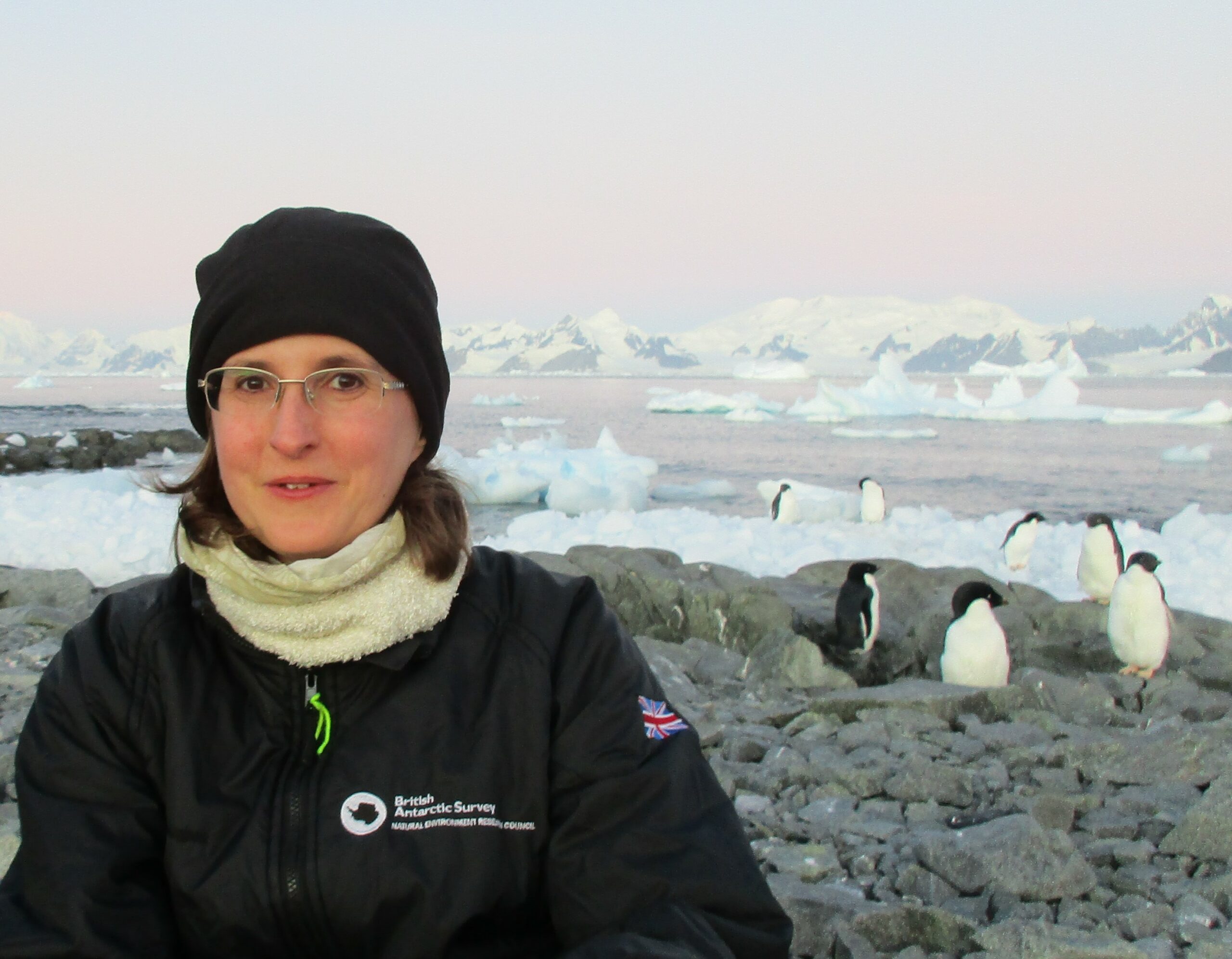 Tracy Moffat-Griffin at Rothera Research Station with Adelie penguins