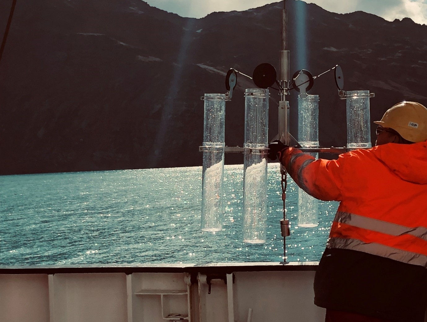 A person standing in front of a body of water