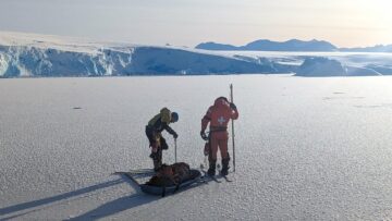 A man standing on top of a snow covered mountain