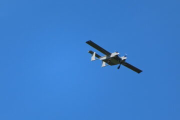 A large passenger jet flying through a clear blue sky