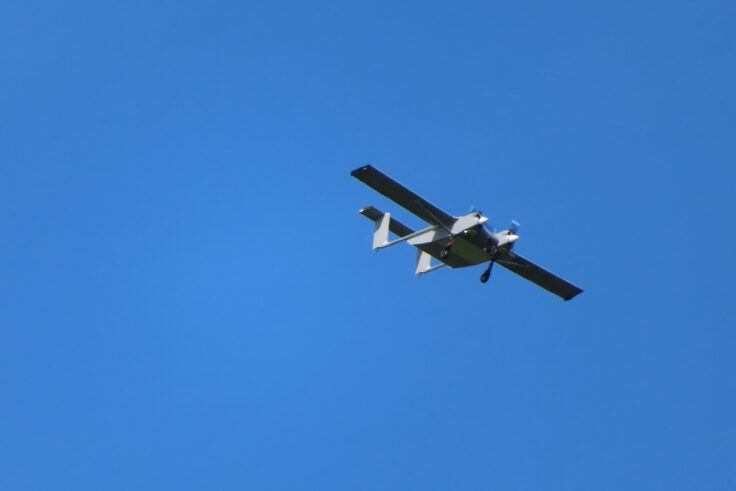 A large passenger jet flying through a clear blue sky