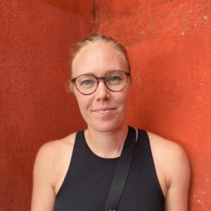 A person wearing glasses posing for the camera