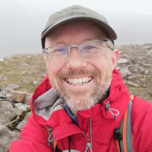 A man wearing a hat and glasses