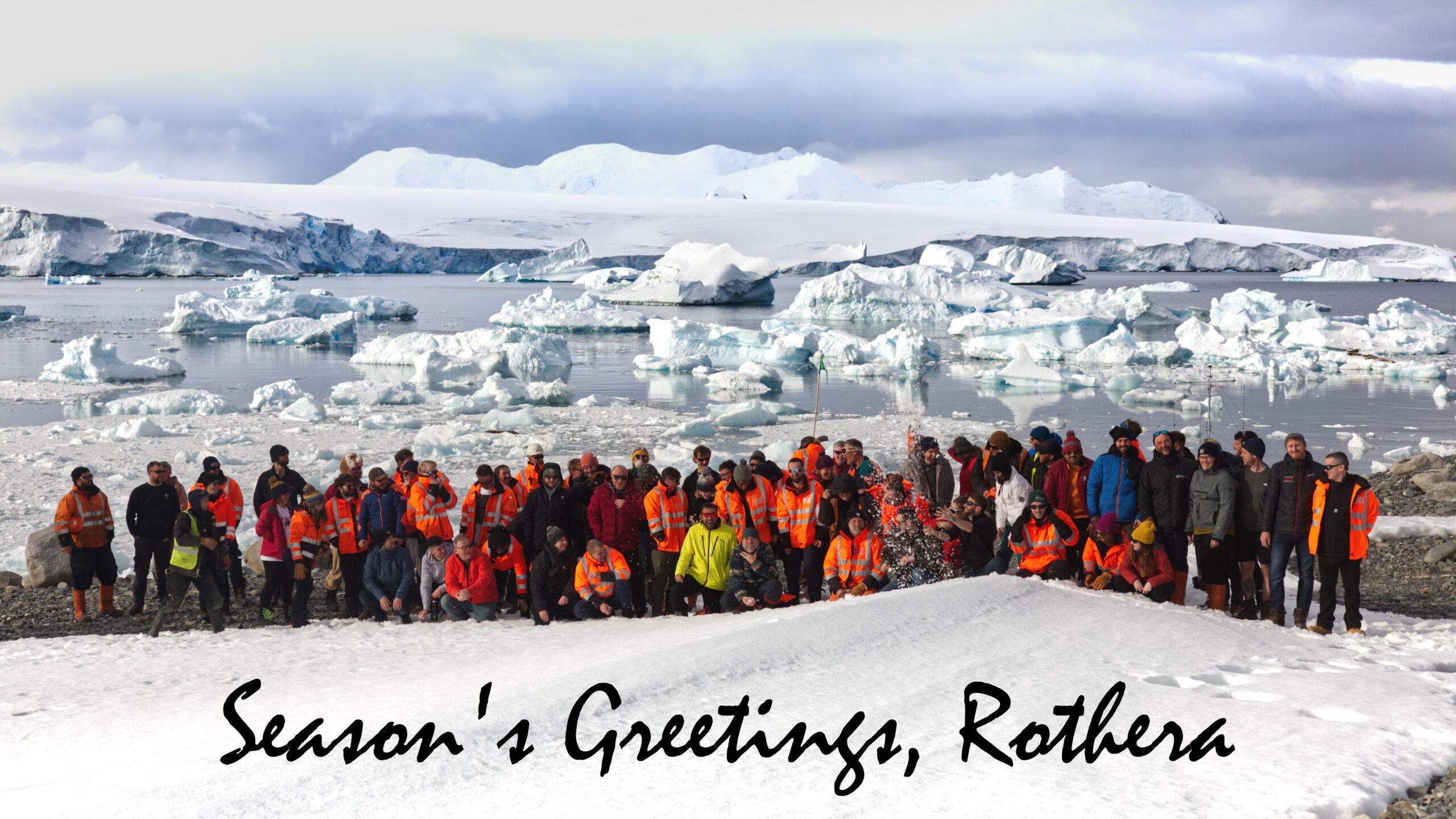A group of people posing for a picture in the snow