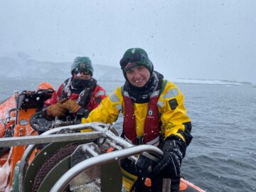 Marine Biologist climbing onto rib in Antarctica