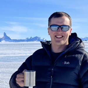 A man standing next to a body of water