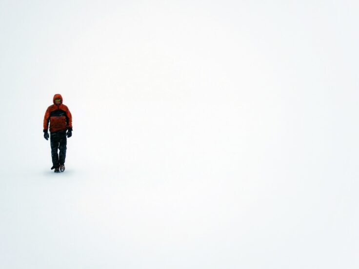 A man standing on top of a snow covered slope