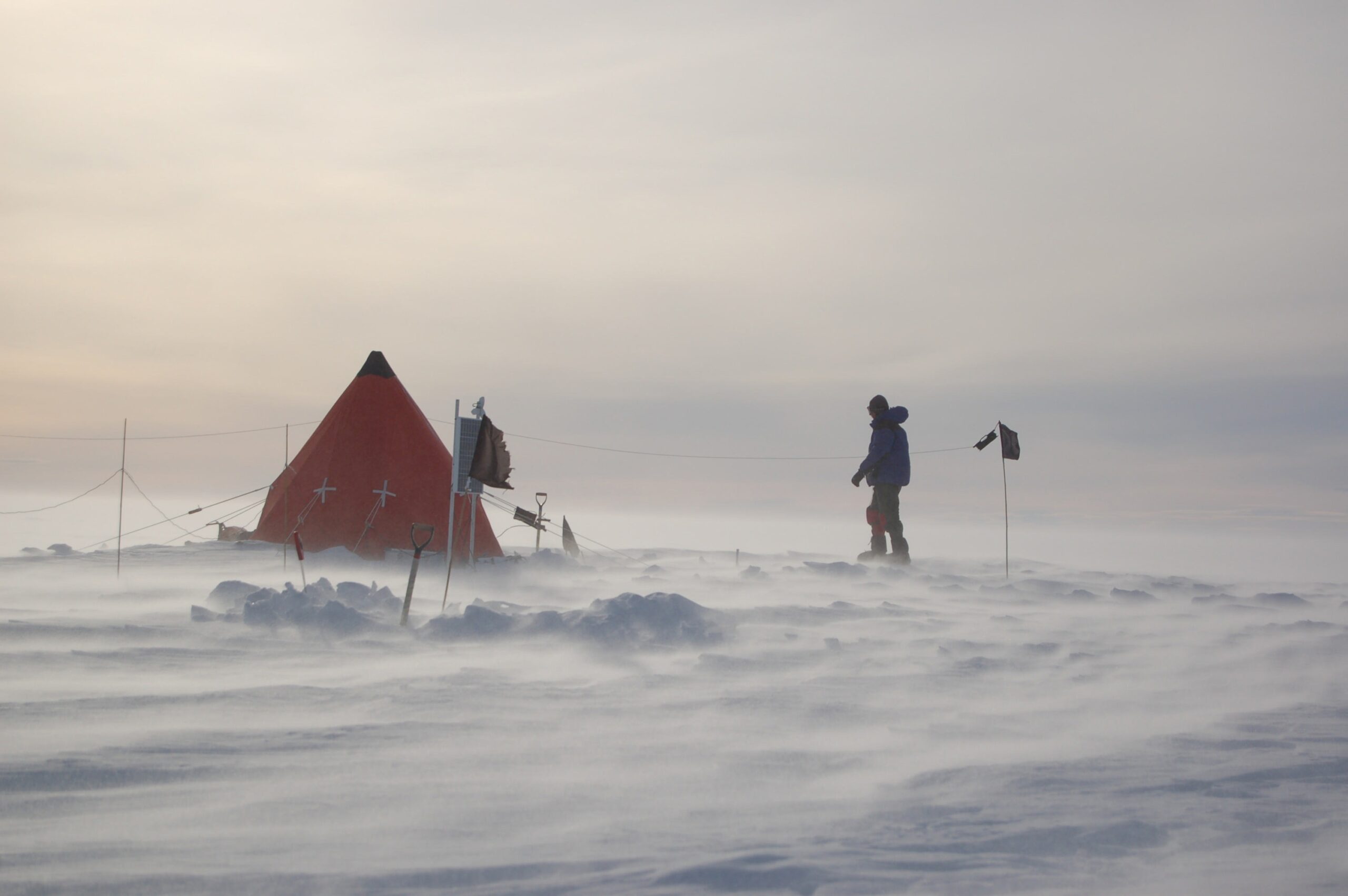 A person and a tent in the snow