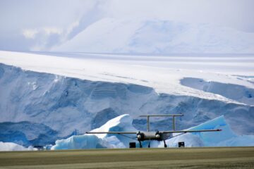 A plane sitting on top of a snow covered mountain