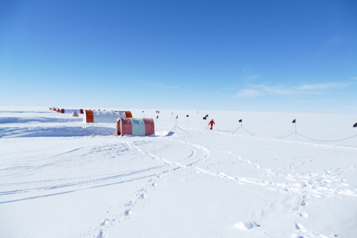 A man riding a snowboard down a snow covered slope