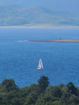 A small boat in a body of water with a mountain in the background