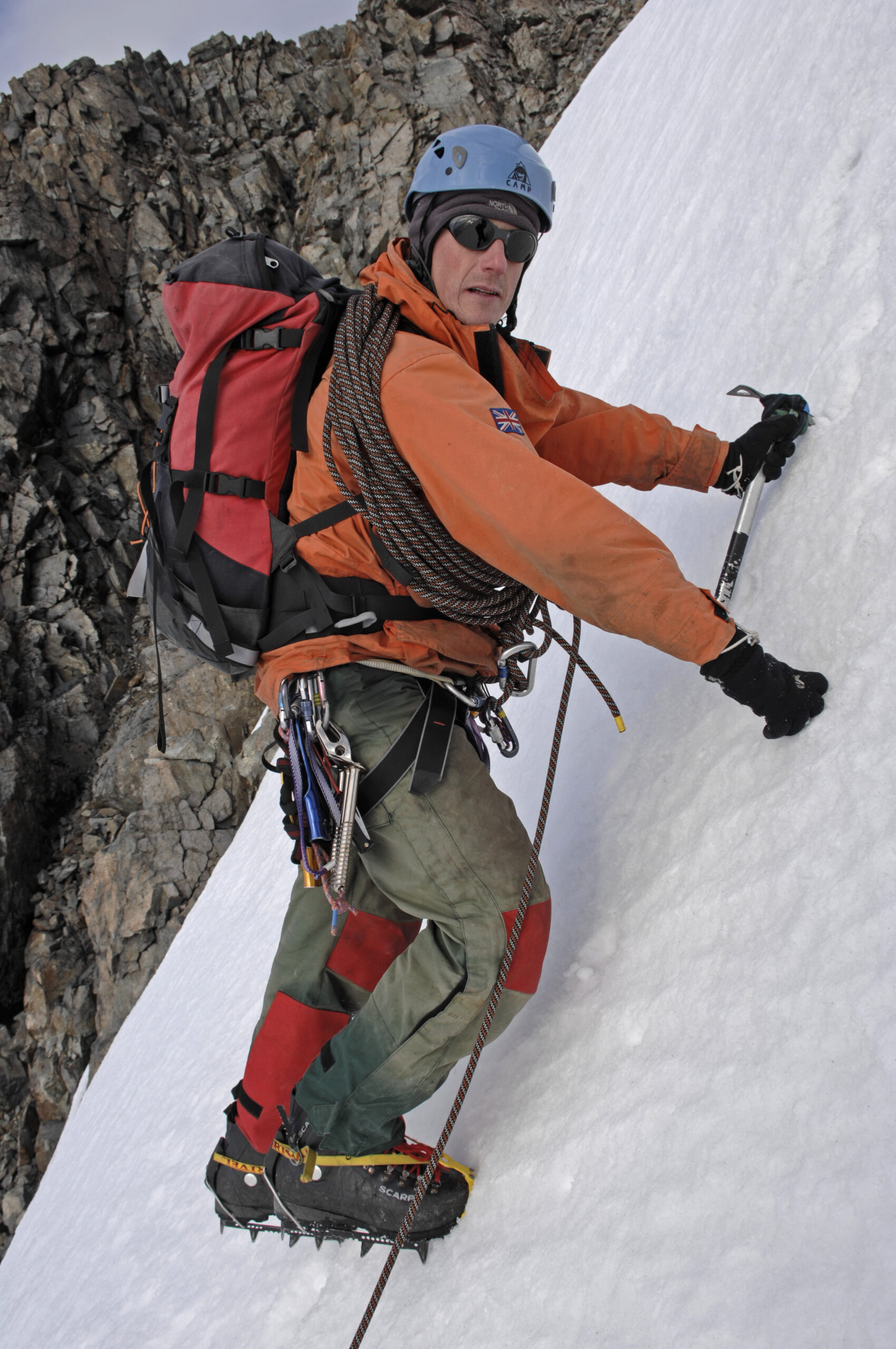 A man climbing up an icy hill