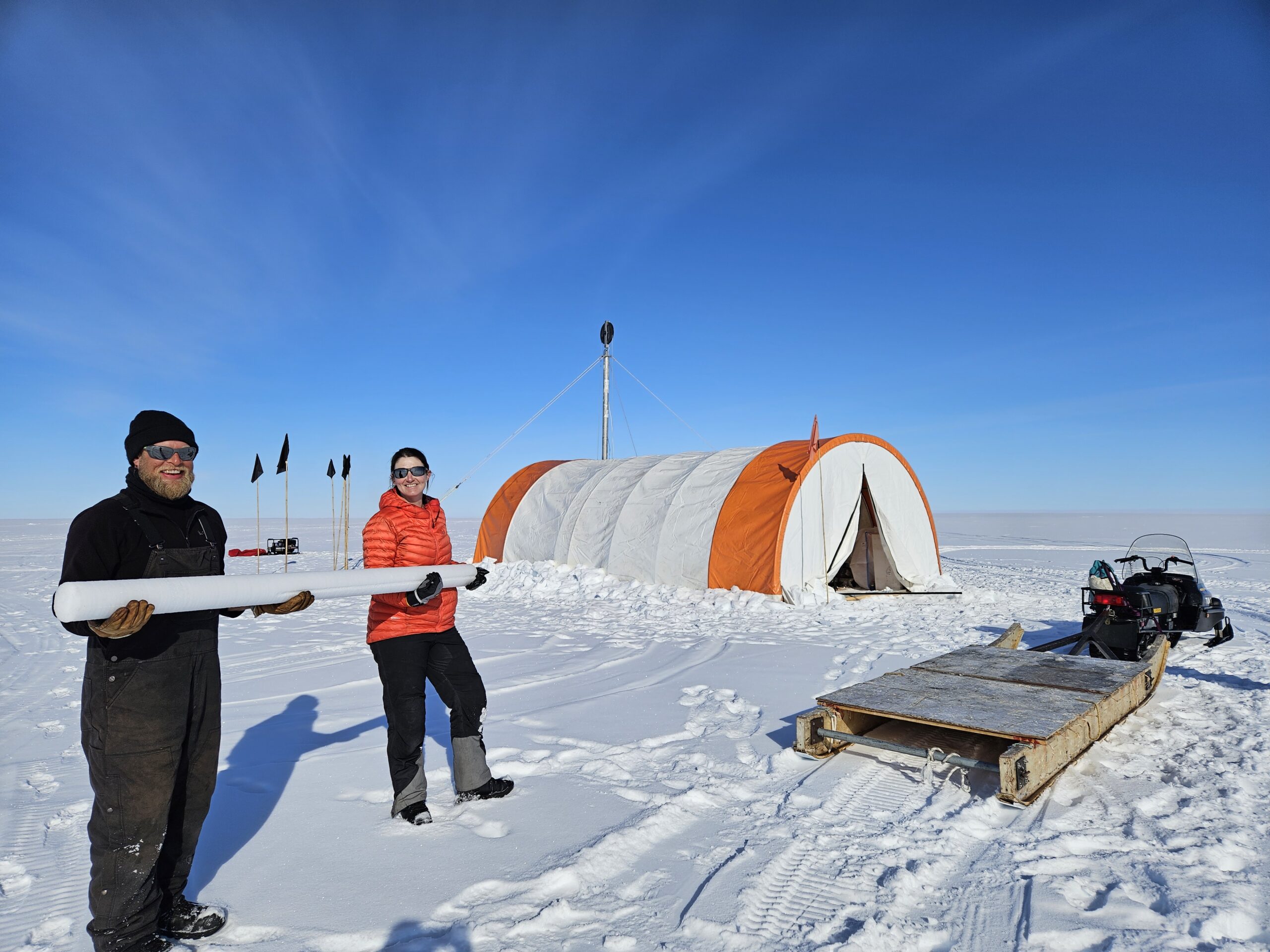 Two people holding an ice core