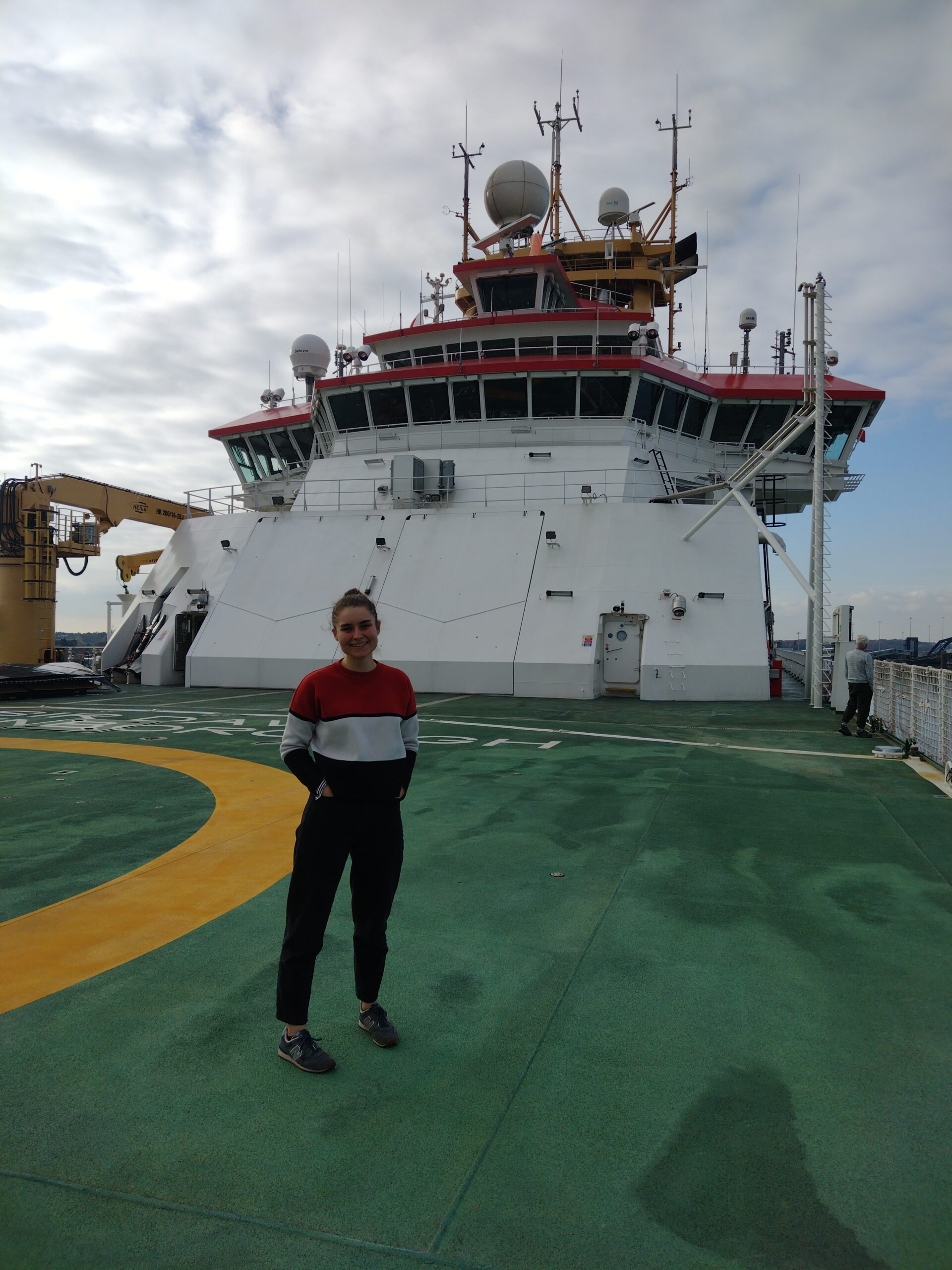 A woman standing on the deck of a ship