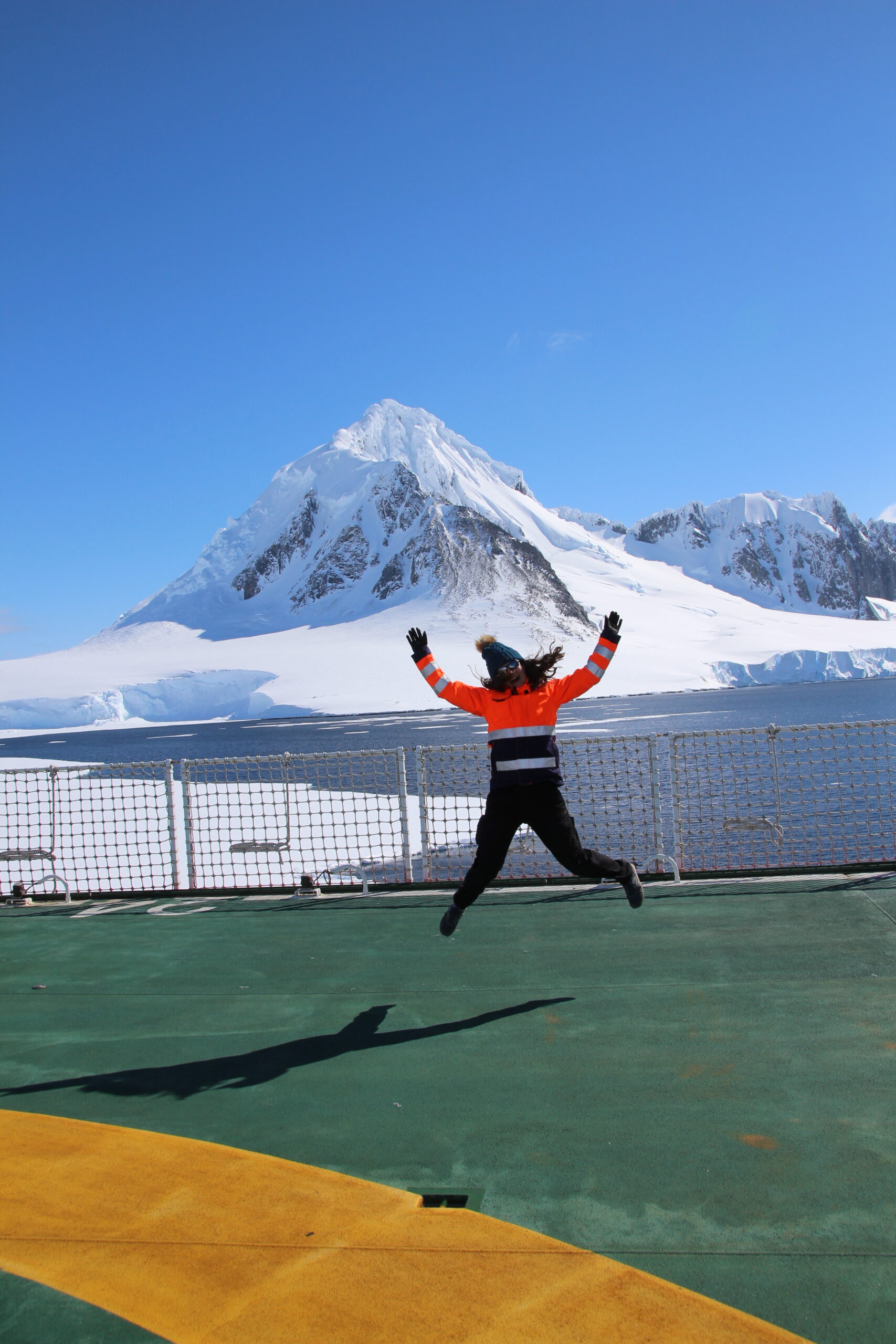 A person standing in front of a snow covered mountain