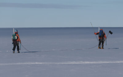 A man is cross country skiing in the water