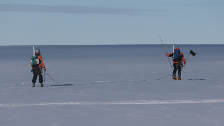 A man is cross country skiing in the water
