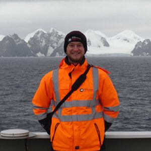 A man standing next to a body of water