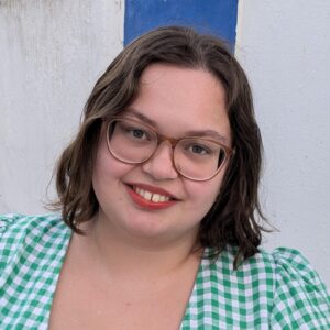 A person wearing glasses and smiling at the camera