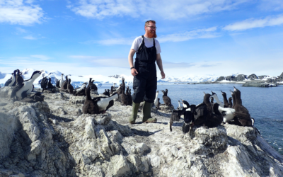 A man standing on a rocky beach