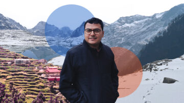 A man standing in front of a snow covered mountain