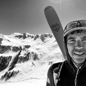 A man standing on top of a snow covered mountain
