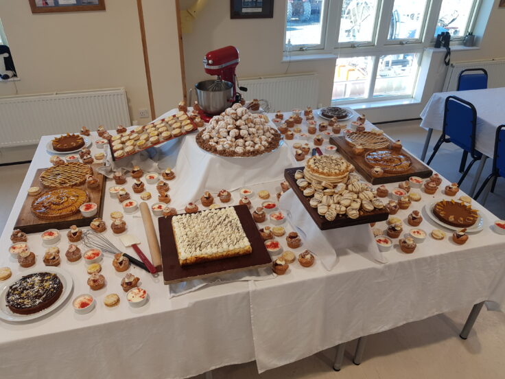 A table with several plates of food on top