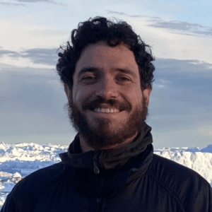 A man standing in front of a mountain