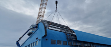 A crane next to a large blue building