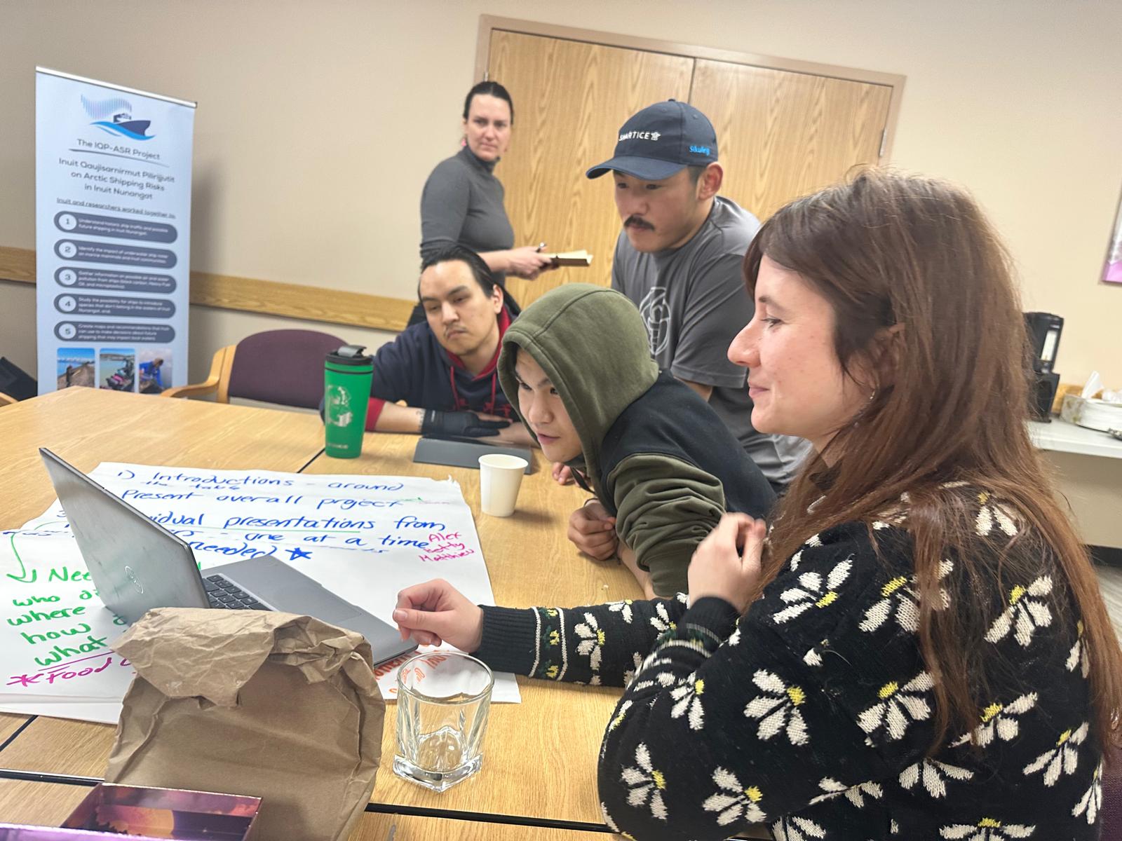 A man and a woman sitting on a table