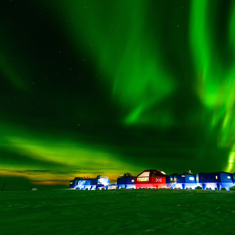 A green aurora illuminating Halley Research Station in Antarctica