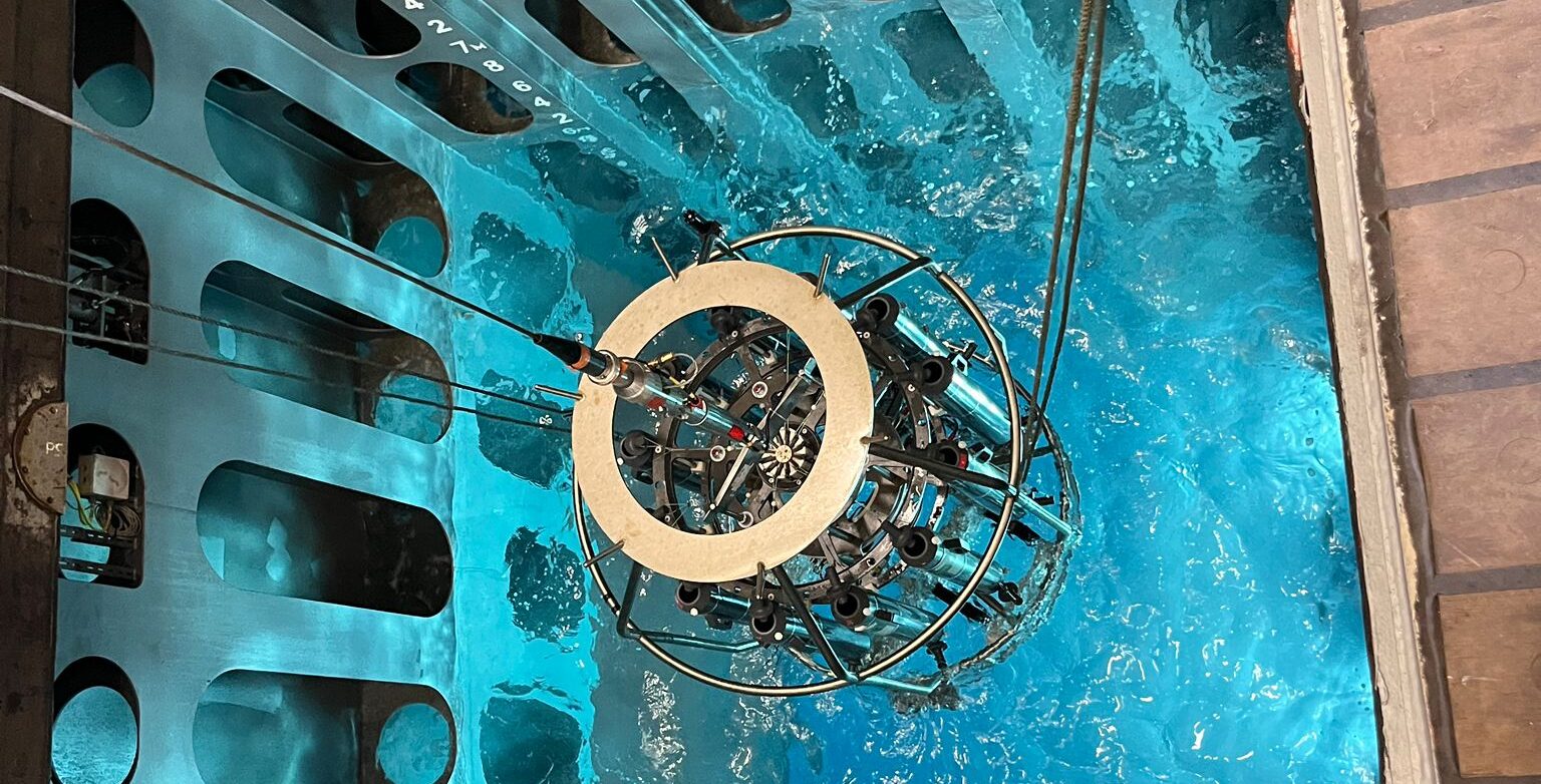 Scientific instrument being lowered into the moonpool.