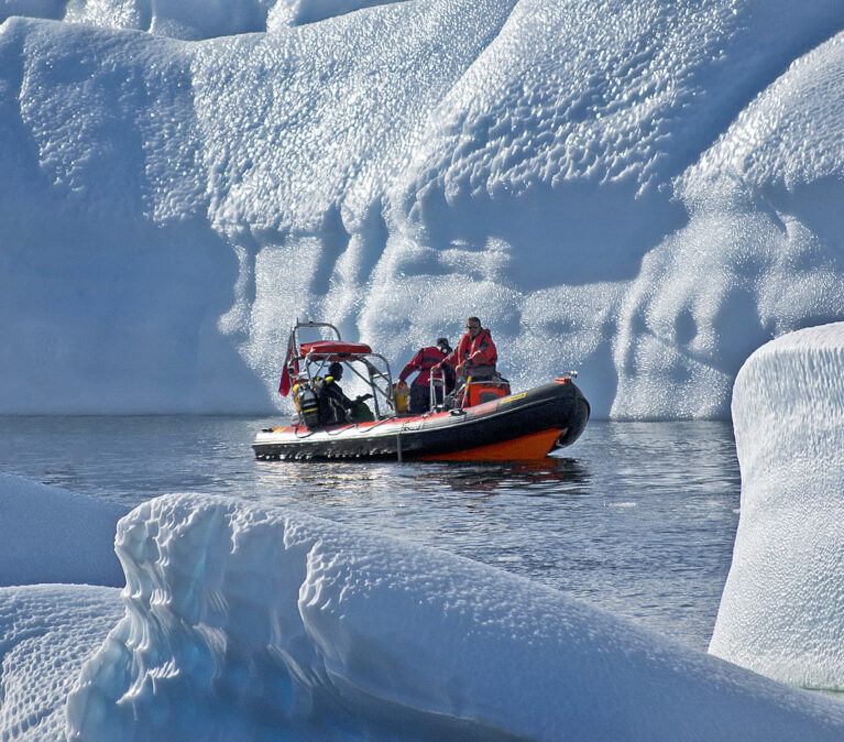 A man riding on top of a snow covered mountain