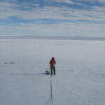 A man riding skis down a snow covered slope