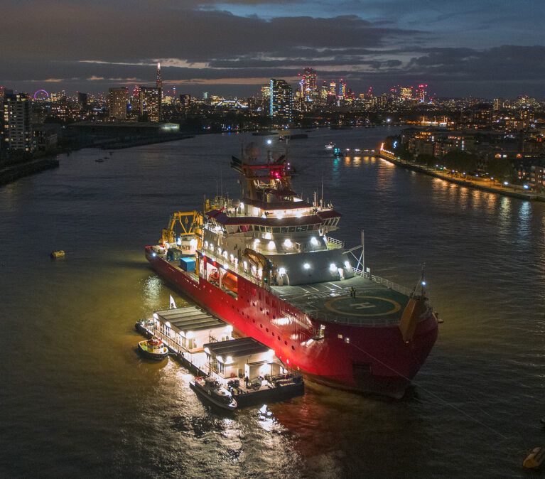 RRS Sir David Attenborough photographed at night in London on the Thames river.