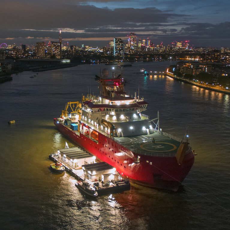 RRS Sir David Attenborough photographed at night in London on the Thames river.