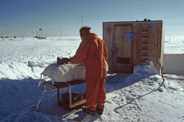 Jon Shanklin in outdoor clothing, using Dobson spectrophotometer outside