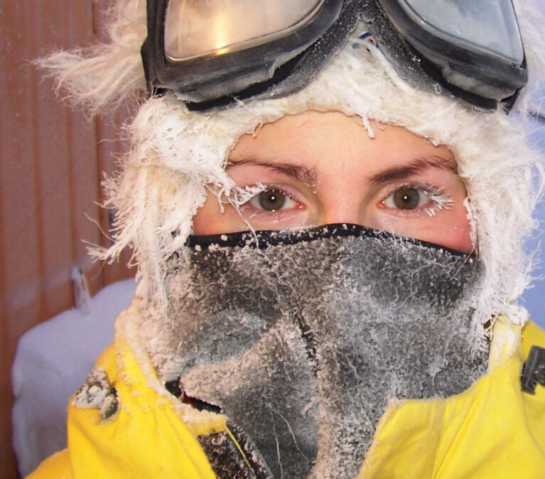 A person wearing a mask posing for the camera