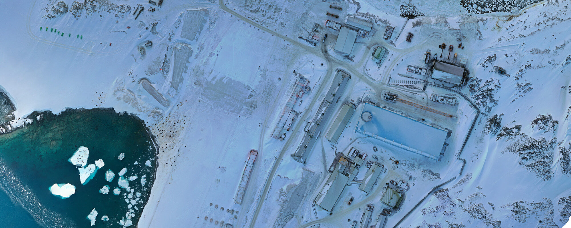 An aerial photograph of a snow blanketed research station