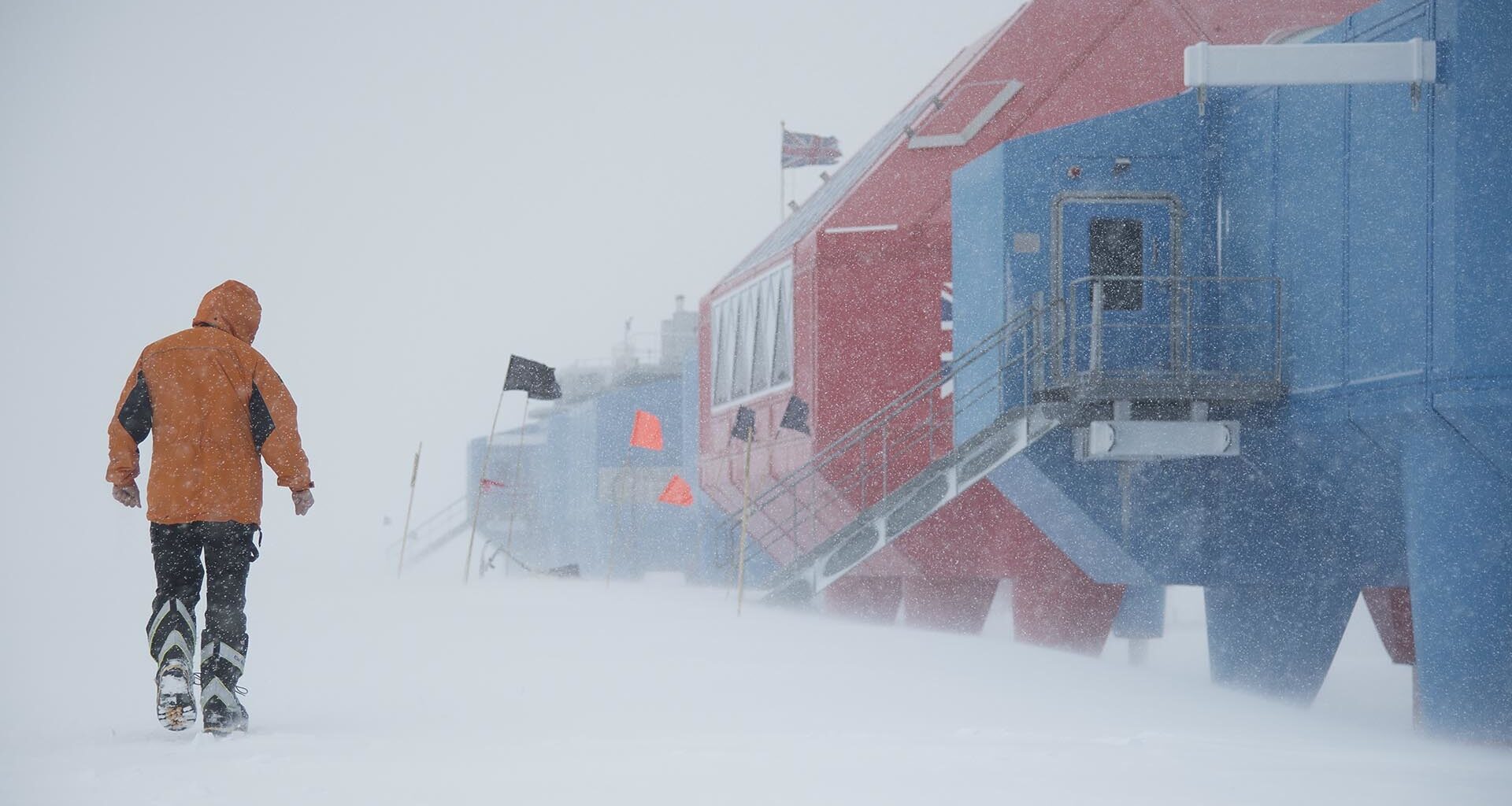 A worker walking to work during an Antarctic snow storm
