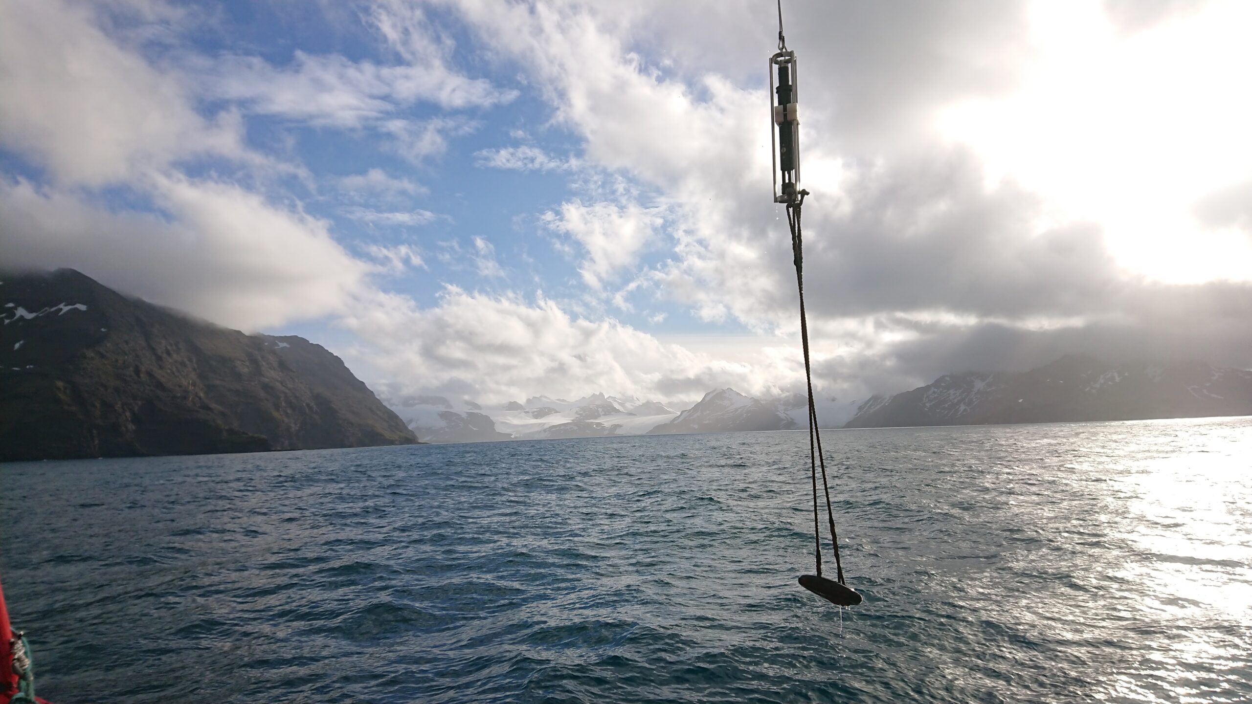 a large body of water with a scientific measuring instrument in. The sky above is cloudy.