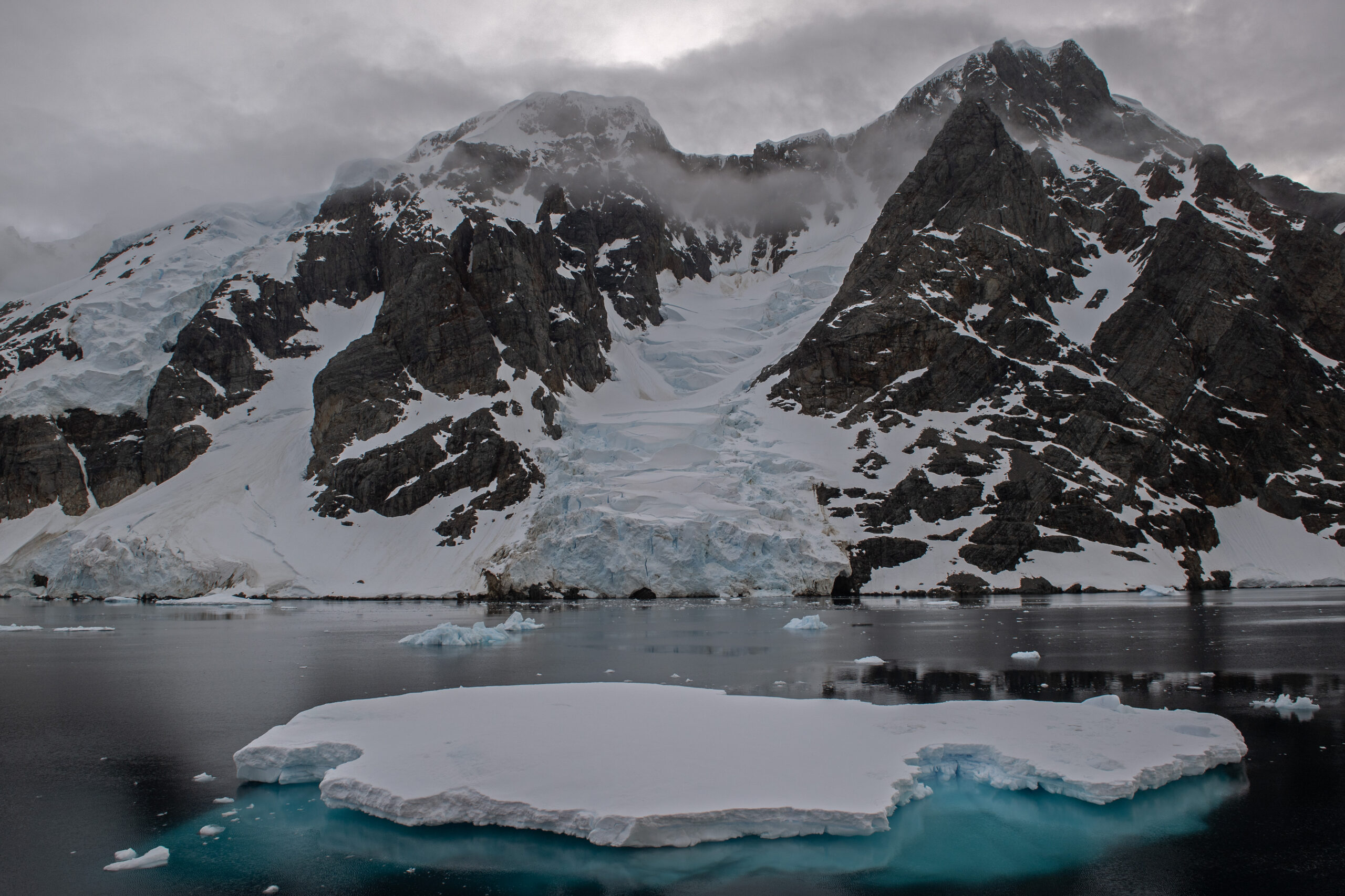 an iceberg in front of a glacier