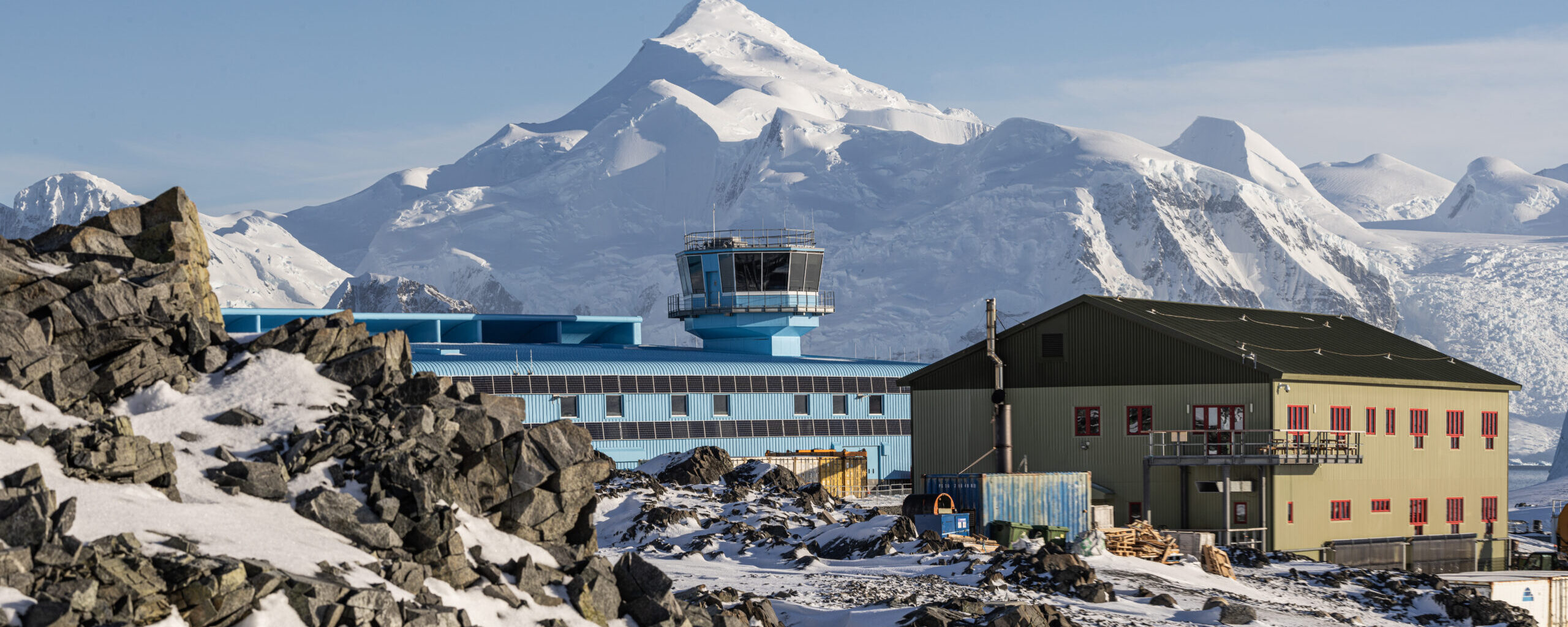 A pile of snow with a mountain in the background