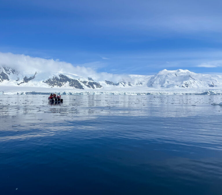 A group of people standing on top of a snow covered mountain