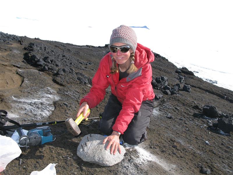 Dr Joanne Johnson breaking open a glacial 'cobble' for analysis.