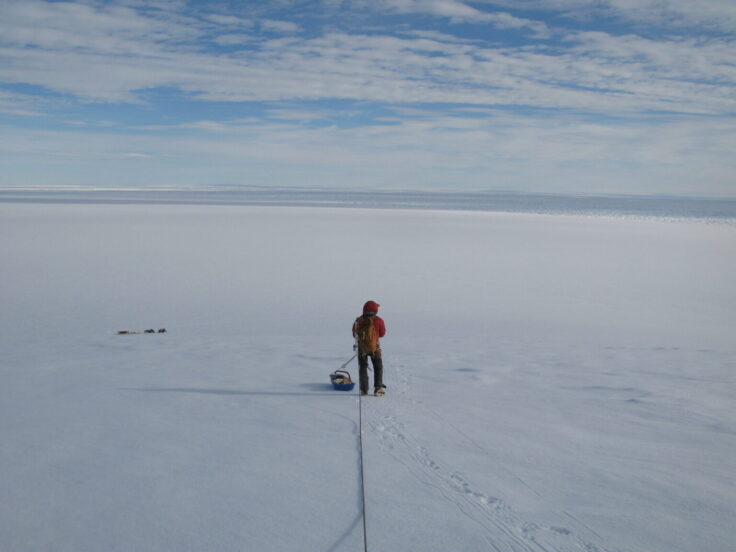 Dr Joanne Johnson standing on ice in Antarctica.
