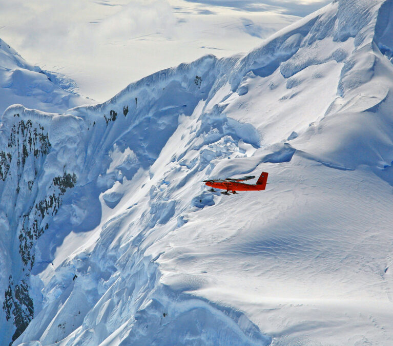A man standing on top of a snow covered mountain