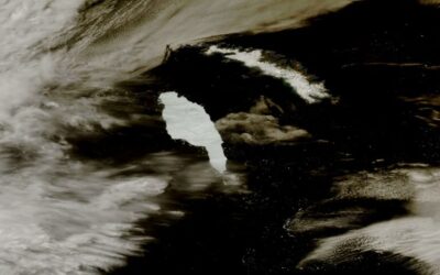 A large waterfall over a body of water