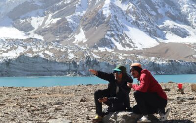 A man sitting on top of a snow covered mountain