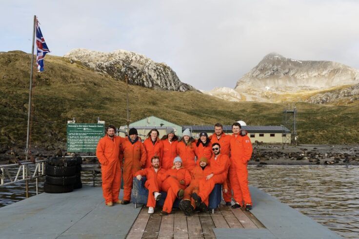A group of people standing in front of the Bird Island research station